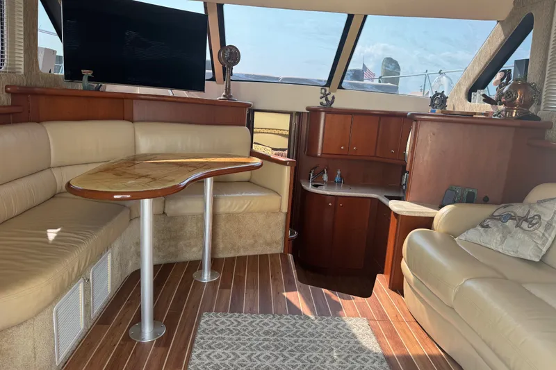 Slide: The Image of Interior of 2005 Silverton 34 Convertible yacht with leather seating and wooden cabinetry. - 33