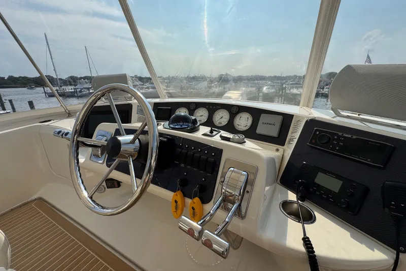 Slide: The Image of 2005 Silverton 34 Convertible boat helm with steering wheel and navigation instruments. - 27
