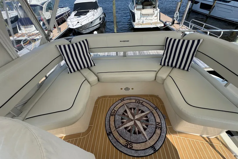 Slide: The Image of Luxurious 2005 Silverton 34 Convertible yacht interior with striped cushions and nautical-themed decor. - 25