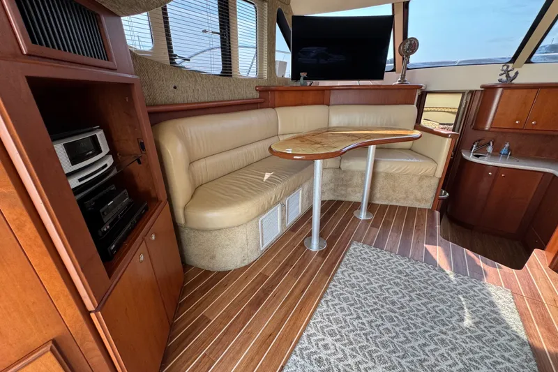 Slide: The Image of Interior of 2005 Silverton 34 Convertible yacht with leather seating and wooden cabinetry. - 39