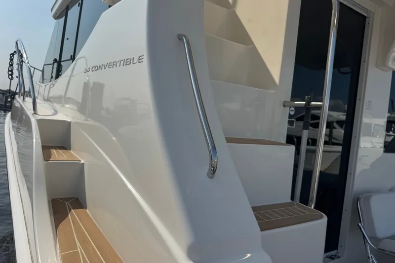 Slide: The Image of 2005 Silverton 34 Convertible yacht with sleek white exterior and wooden steps. - 23