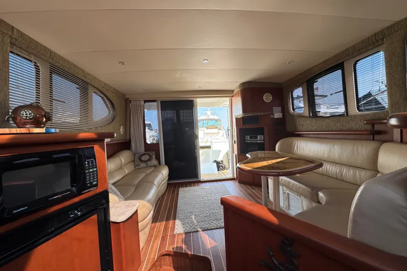 Slide: The Image of Luxurious interior of a 2005 Silverton 34 Convertible yacht with leather seating and wood accents. - 36