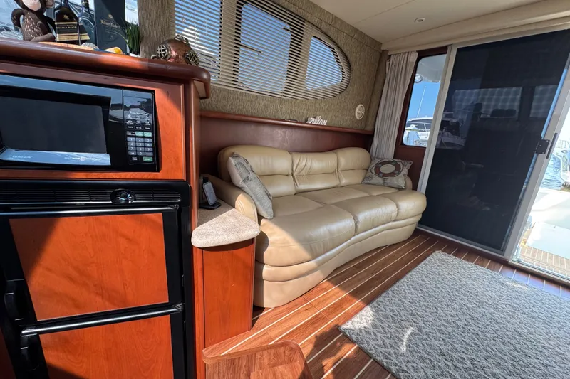 Slide: The Image of Interior of 2005 Silverton 34 Convertible yacht with leather sofa and kitchenette. - 35