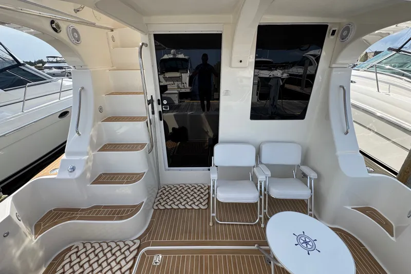 Slide: The Image of 2005 Silverton 34 Convertible yacht interior with seating and stairs, featuring modern design elements. - 20