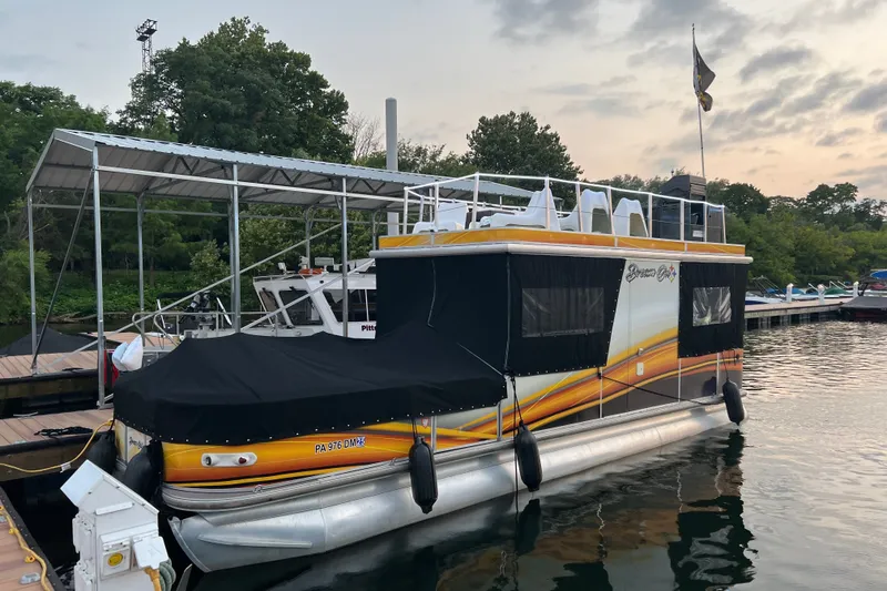 The Image of 2007 TRACKER MARINE Party Hut 30 pontoon boat docked at marina, featuring upper deck seating. - 0