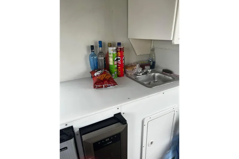 Slide: The Image of 2007 TRACKER MARINE Party Hut 30 kitchenette with snacks and beverages on counter. - 14