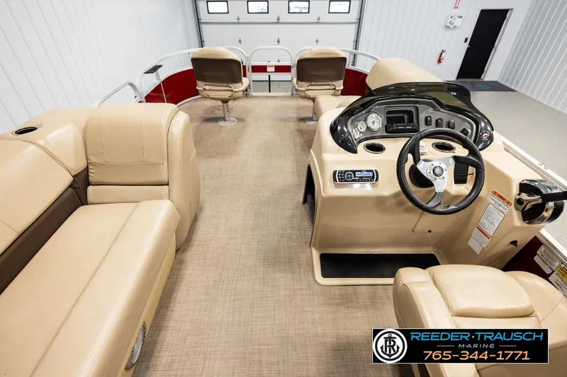 Slide: The Image of Interior view of 2019 SUNTRACKER 20 DLX pontoon boat with beige seating and control panel. - 17
