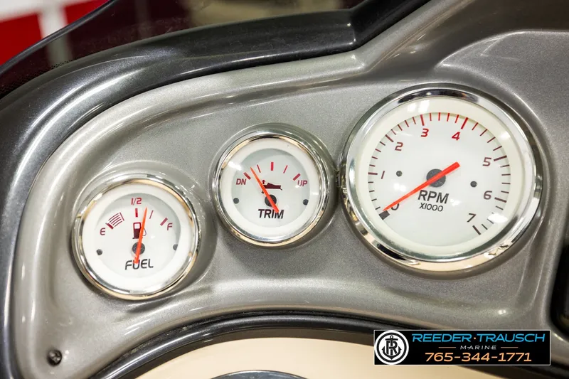 Slide: The Image of Dashboard gauges of a 2019 SUNTRACKER 20 DLX boat, showing fuel, trim, and RPM levels. - 36