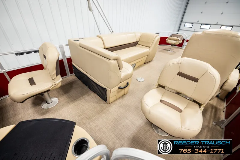 Slide: The Image of 2019 SUNTRACKER 20 DLX pontoon boat interior with beige seating and carpeted flooring. - 30