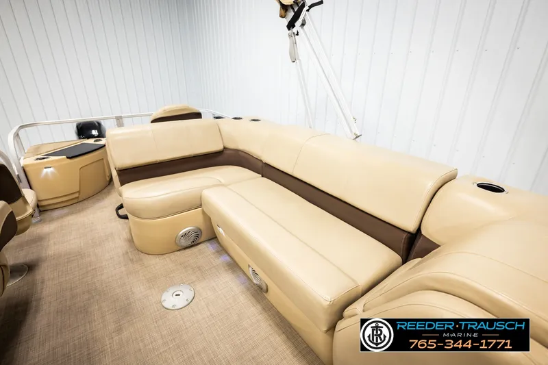 Slide: The Image of 2019 SUNTRACKER 20 DLX pontoon boat interior with beige seating and cup holders. - 25