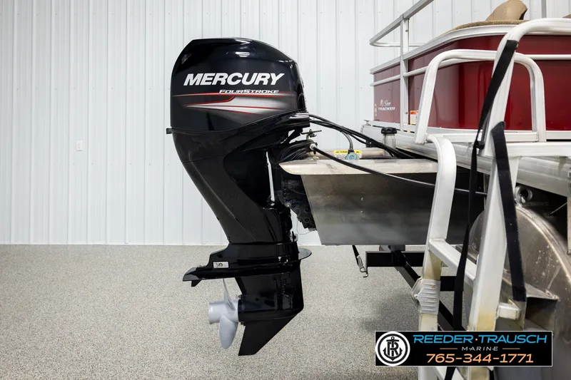 Slide: The Image of 2019 SUNTRACKER 20 DLX boat with Mercury FourStroke outboard motor in a showroom. - 49