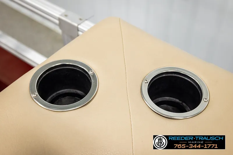 Slide: The Image of Cup holders on 2019 SUNTRACKER 20 DLX boat, beige upholstery, Reeder Trausch Marine contact info. - 46