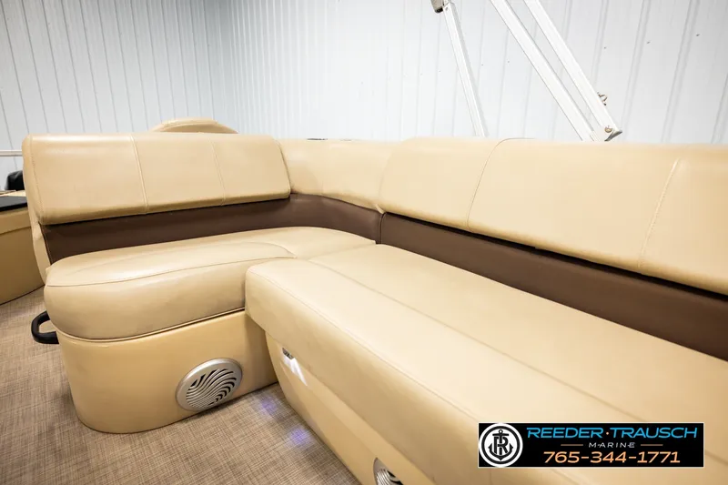 Slide: The Image of 2019 SUNTRACKER 20 DLX boat interior with beige seating and speaker detail. - 44