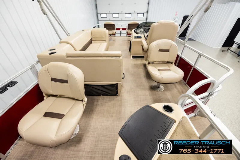 Slide: The Image of Interior of a 2019 SUNTRACKER 20 DLX pontoon boat with beige seating and steering console. - 16