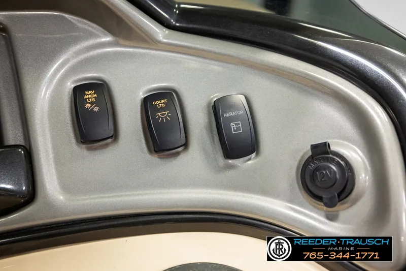 Slide: The Image of Control panel of 2019 SUNTRACKER 20 DLX boat with switches and 12V outlet. - 38