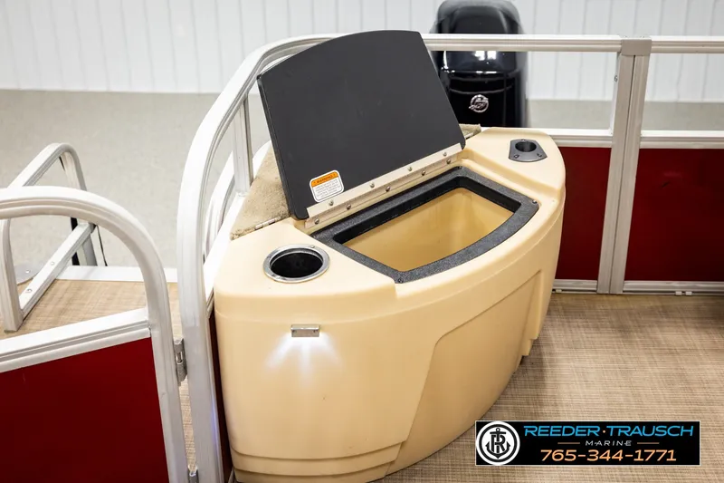 Slide: The Image of 2019 SUNTRACKER 20 DLX boat interior with storage compartment and cup holder. - 28