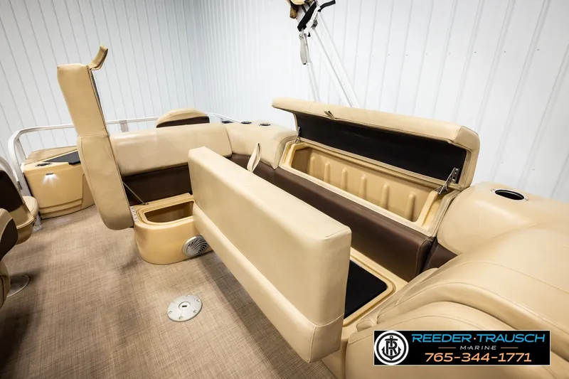 Slide: The Image of 2019 SUNTRACKER 20 DLX boat interior with beige seating and storage compartments. - 26