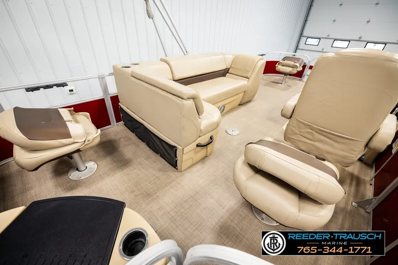 Slide: The Image of 2019 SUNTRACKER 20 DLX pontoon boat interior with beige seating and spacious layout. - 29