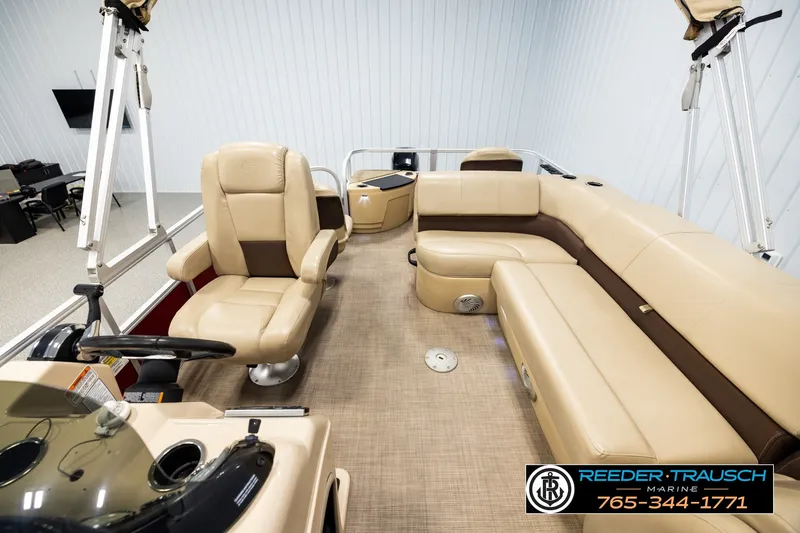 Slide: The Image of Interior of 2019 SUNTRACKER 20 DLX pontoon boat with beige seating and steering console. - 14