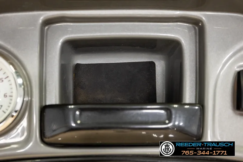 Slide: The Image of Dashboard compartment of 2019 SUNTRACKER 20 DLX boat with gauge and Reeder-Trausch Marine logo. - 37