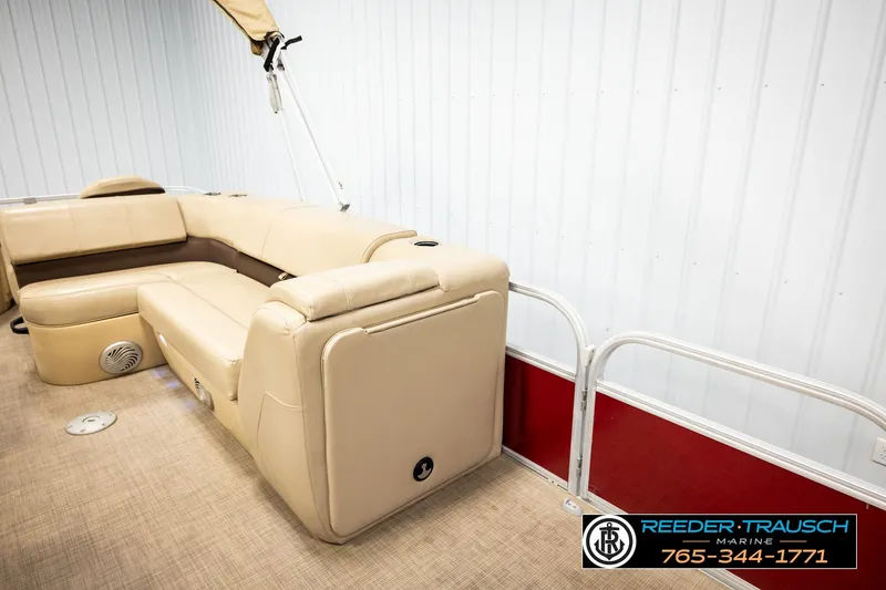Slide: The Image of 2019 SUNTRACKER 20 DLX pontoon boat interior with beige seating and carpeted floor. - 23