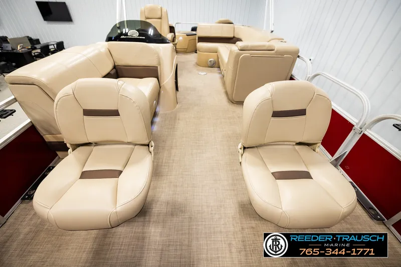Slide: The Image of 2019 SUNTRACKER 20 DLX pontoon boat interior with beige seating and carpet flooring. - 22
