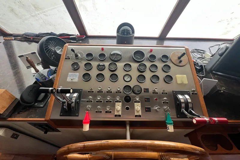 Slide: The Image of Control panel of a 1982 Pluckebaum Coastal Cruiser with gauges and levers. - 8