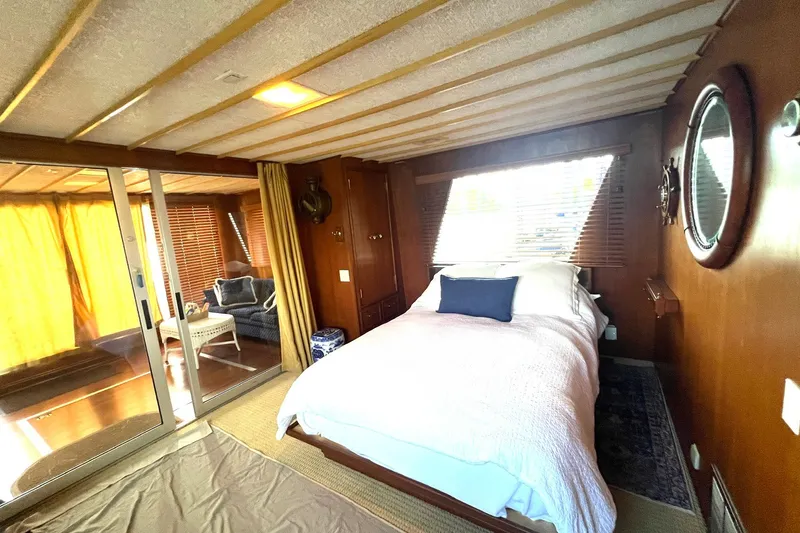 Slide: The Image of Cozy bedroom in 1982 Pluckebaum Coastal Cruiser with nautical decor and sliding glass doors. - 20