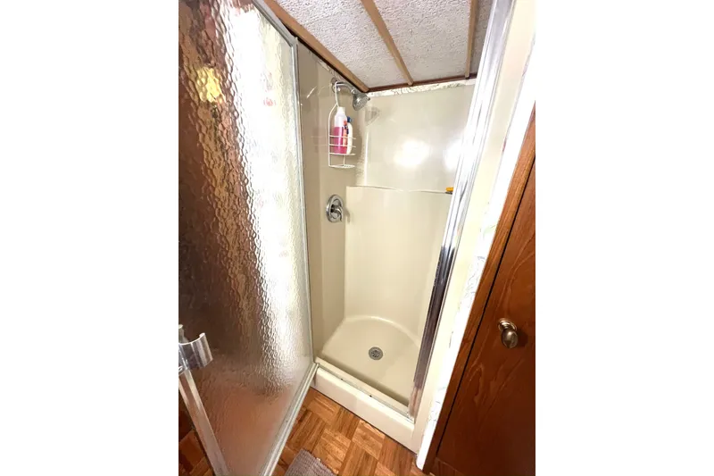 Slide: The Image of Shower area in 1982 Pluckebaum Coastal Cruiser with glass door and beige interior. - 37