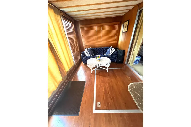 Slide: The Image of Cozy interior of 1982 Pluckebaum Coastal Cruiser with wooden flooring and comfortable seating. - 25