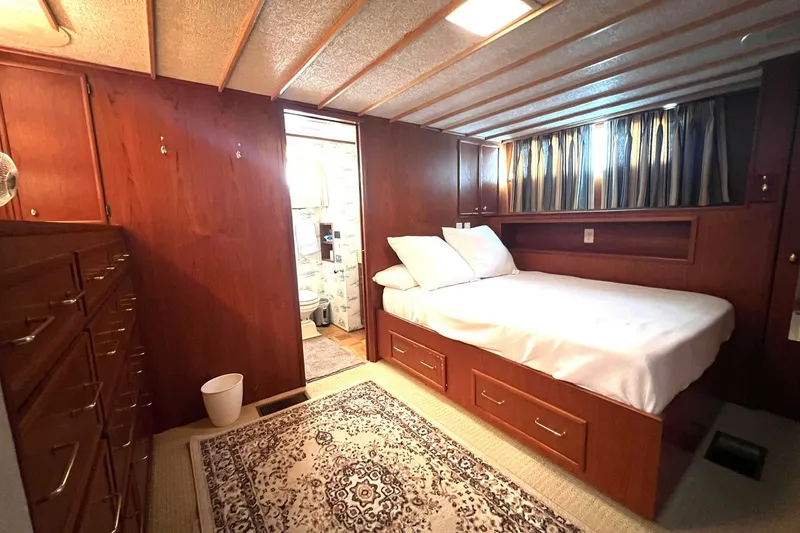 Slide: The Image of Cozy bedroom in 1982 Pluckebaum Coastal Cruiser with wood paneling and carpet. - 30