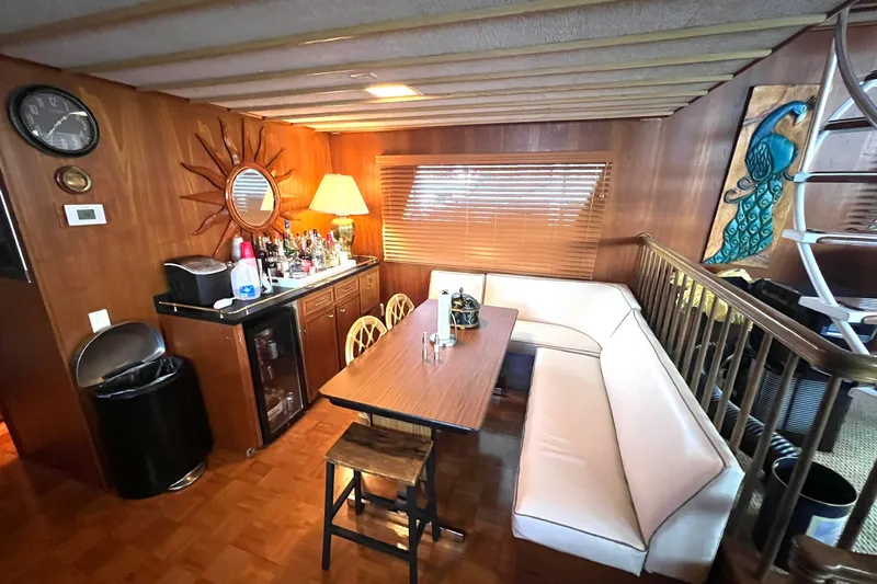 Slide: The Image of Interior of 1982 Pluckebaum Coastal Cruiser with dining area and bar setup. - 15