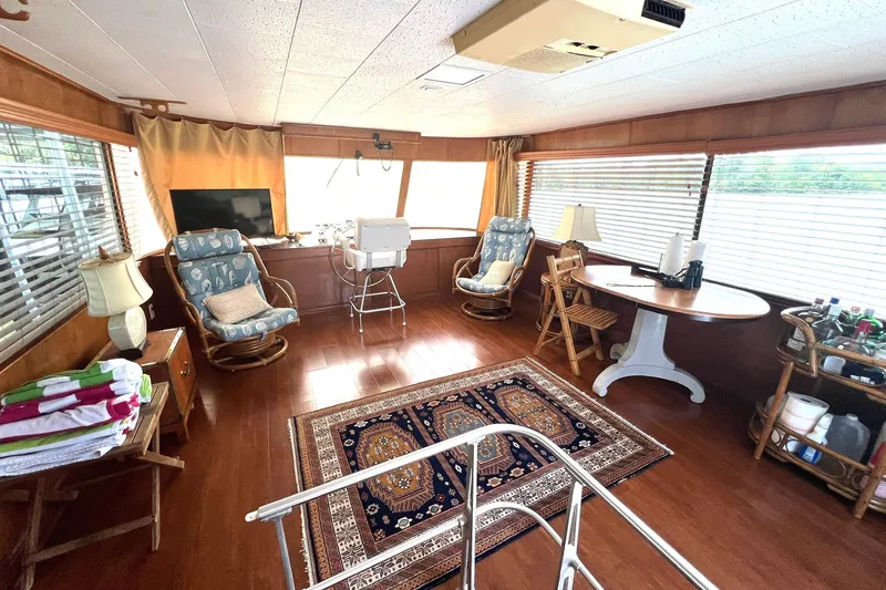 Slide: The Image of Interior of 1982 Pluckebaum Coastal Cruiser with wooden decor and seating area. - 13