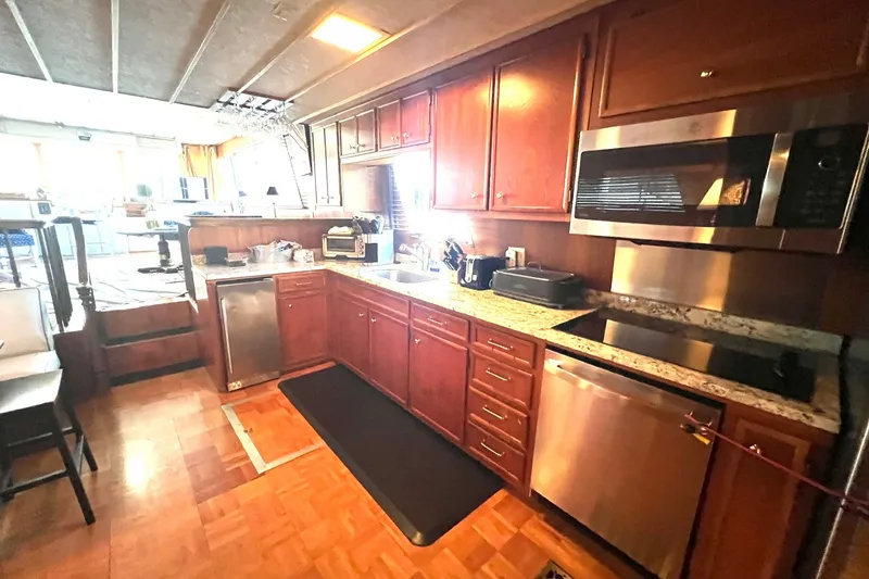 Slide: The Image of Kitchen interior of 1982 Pluckebaum Coastal Cruiser with modern appliances and wooden cabinetry. - 18