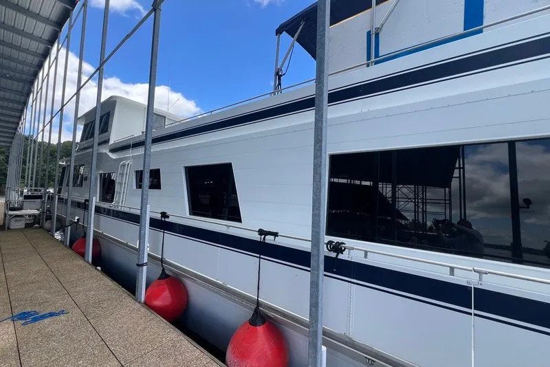 Slide: The Image of 1982 Pluckebaum Coastal Cruiser docked with red fenders, under a blue sky. - 3