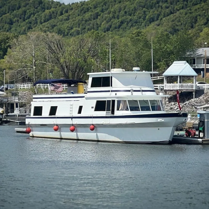 The Image of 1982 Pluckebaum Coastal Cruiser docked at marina with scenic background. - 0