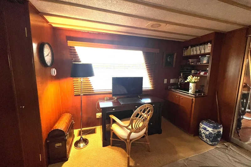Slide: The Image of Cozy 1982 Pluckebaum Coastal Cruiser interior with desk, chair, and window lighting. - 24