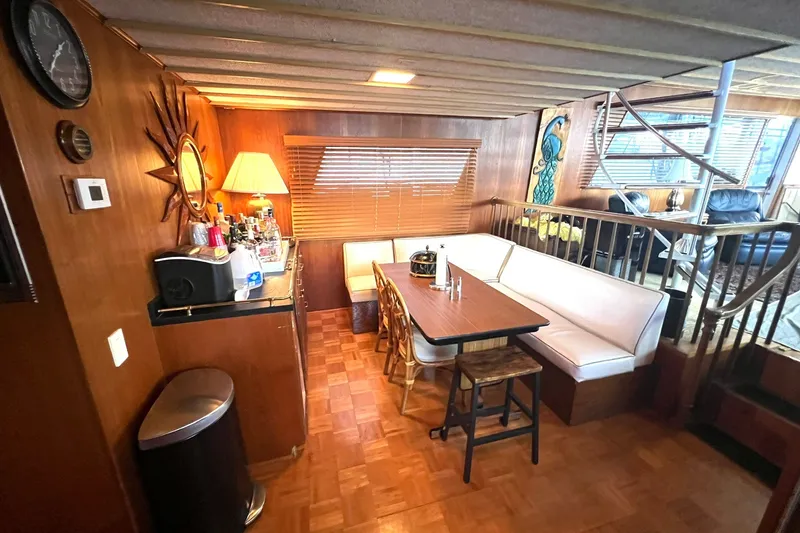 Slide: The Image of Interior of 1982 Pluckebaum Coastal Cruiser with cozy dining area and bar setup. - 14