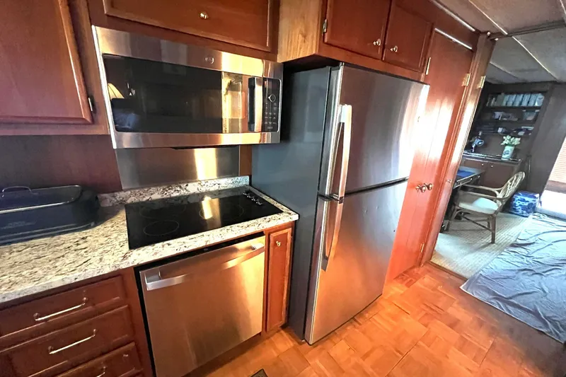 Slide: The Image of Modern kitchen in 1982 Pluckebaum Coastal Cruiser with stainless steel appliances. - 16