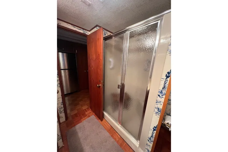 Slide: The Image of Shower area in 1982 Pluckebaum Coastal Cruiser with wooden door and textured glass. - 27