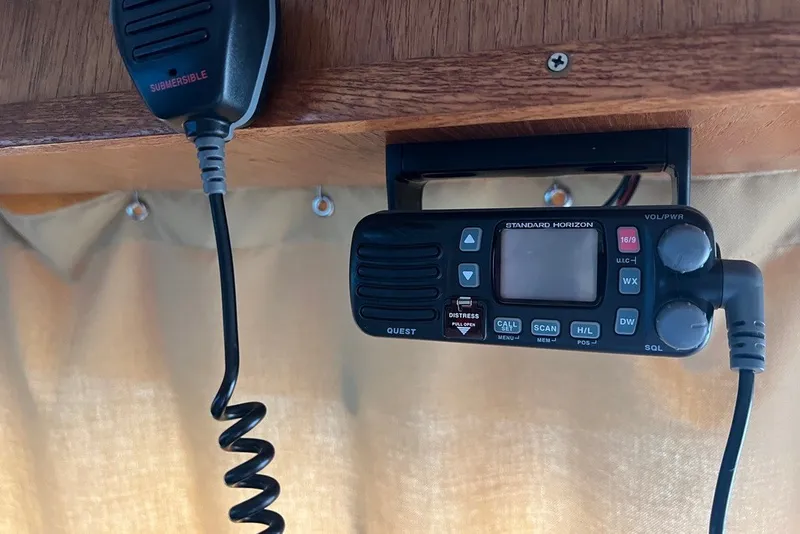 Slide: The Image of VHF marine radio on 1982 Pluckebaum Coastal Cruiser, featuring a submersible microphone. - 44