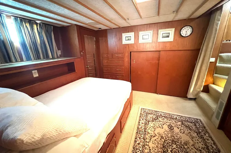 Slide: The Image of Cozy bedroom in 1982 Pluckebaum Coastal Cruiser with wood paneling and nautical decor. - 29