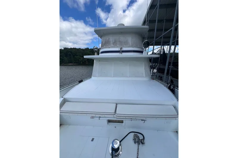 Slide: The Image of 1982 Pluckebaum Coastal Cruiser yacht docked, showcasing its spacious deck and sleek design. - 5