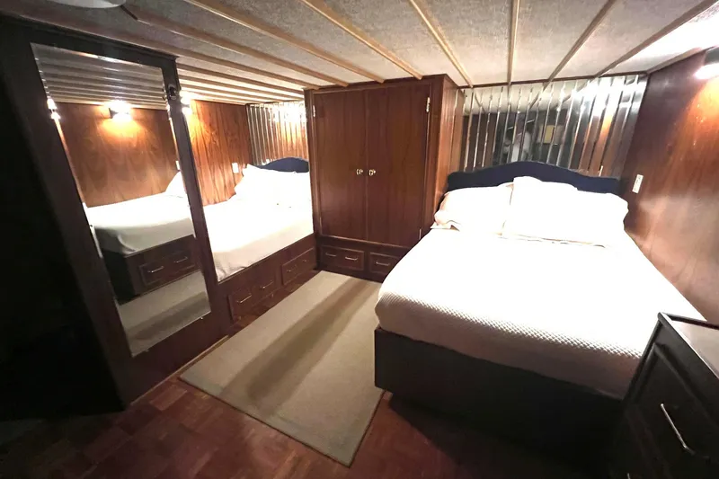 Slide: The Image of Cozy bedroom interior of 1982 Pluckebaum Coastal Cruiser with wood paneling and mirrored closet. - 34