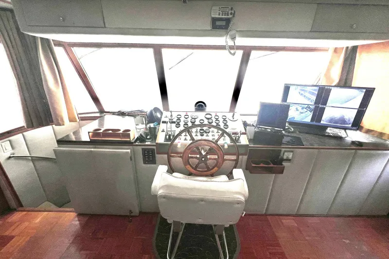 Slide: The Image of Interior helm of 1982 Pluckebaum Coastal Cruiser with steering wheel and control panels. - 7