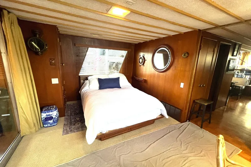 Slide: The Image of 1982 Pluckebaum Coastal Cruiser bedroom with wooden interior, bed, and nautical decor. - 21