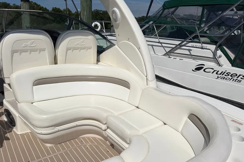 Slide: The Image of 2004 Sea Ray 340 Sundancer boat with white leather seating and elegant design. - 5