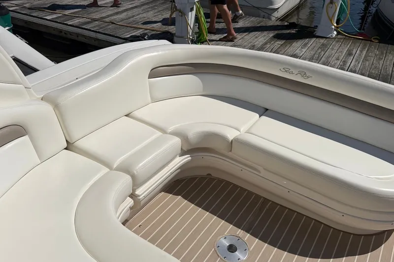 Slide: The Image of 2004 Sea Ray 340 Sundancer boat with white leather seating and wooden deck. - 4