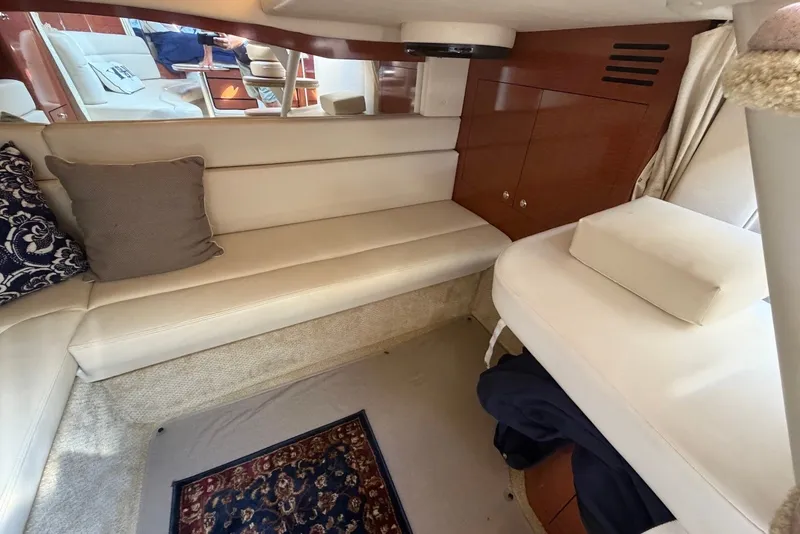 Slide: The Image of Interior of 2004 Sea Ray 340 Sundancer with beige seating and decorative pillows. - 24