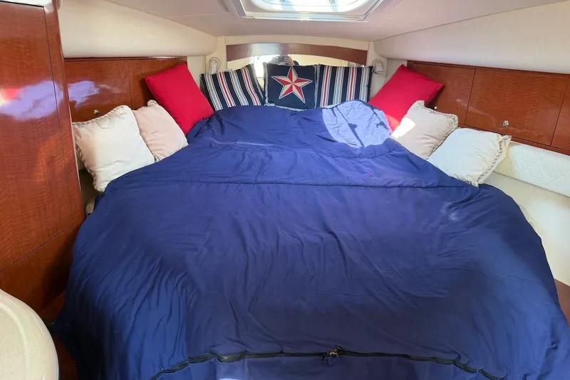 Slide: The Image of Luxurious cabin interior of 2004 Sea Ray 340 Sundancer with cozy bedding and pillows. - 29